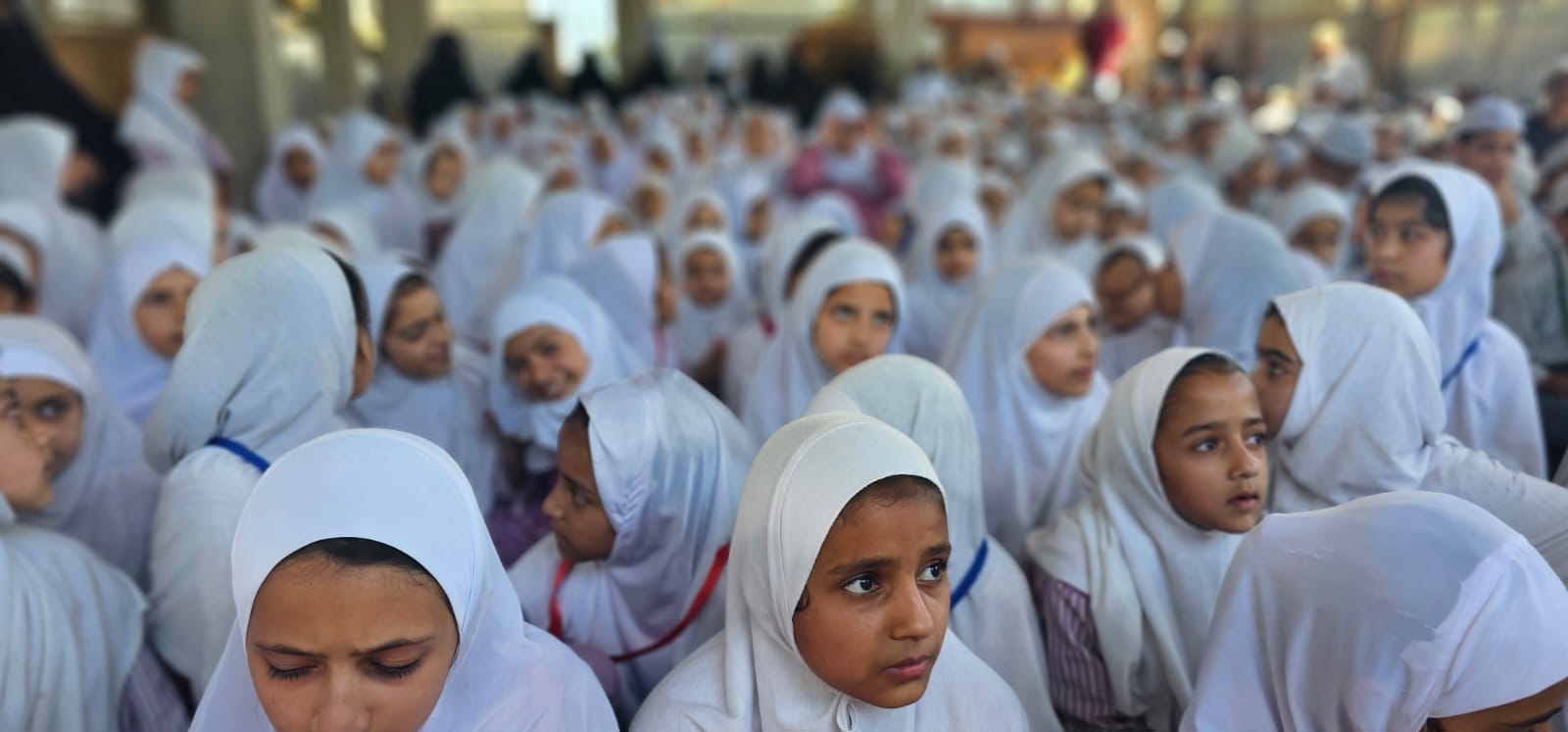 Girls listening attentively during the morning assembly.